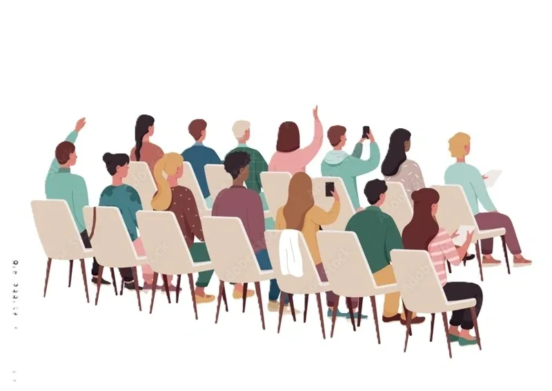 Audience seated in chairs, some raising hands.